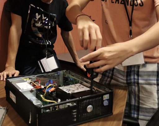 Freshman taking a computer apart.