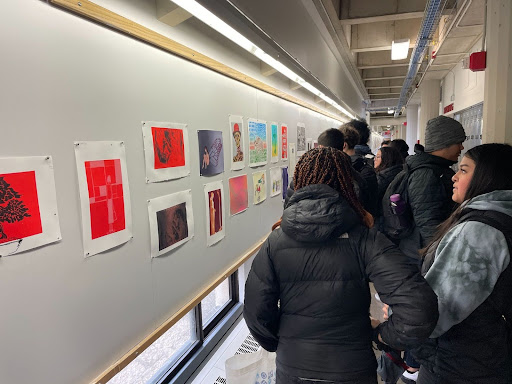 ITA students admiring artwork in the Humanities building on campus.